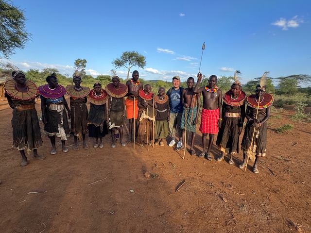 Maasai guide explaining traditional beadwork to guest