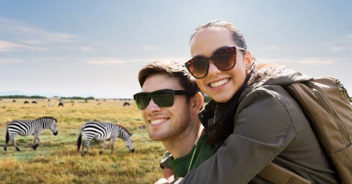 Couple at a safari camp at dusk, Kenya